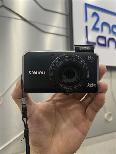 Máy ảnh Canon Power Shot SX210 IS - Màu Xanh Đen - Ngoại hình xấu - đóm, viền tối - Kèm 2 pin + 1 sạc