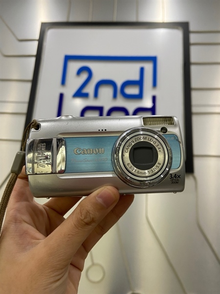 Máy ảnh Canon Powershot A470 - Màu bạc - Ngoại hình: 97% - Kẹt lá che lens, màn trầy, màn bị loạng sáng, hết pin cmos , mất nắp cổng kết nối - Kèm 4 pin 2a, dock sạc, thẻ nhớ 2GB - không bảo hành